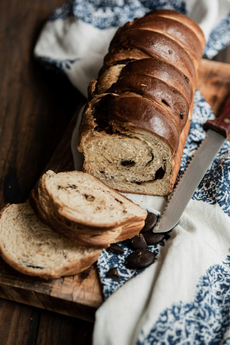 A swirled loaf sliced on a wooden board